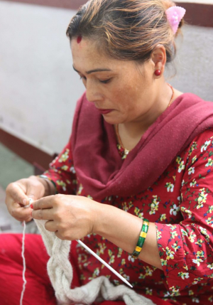 Women hand knitting with wool at Rochak Handknit Craft